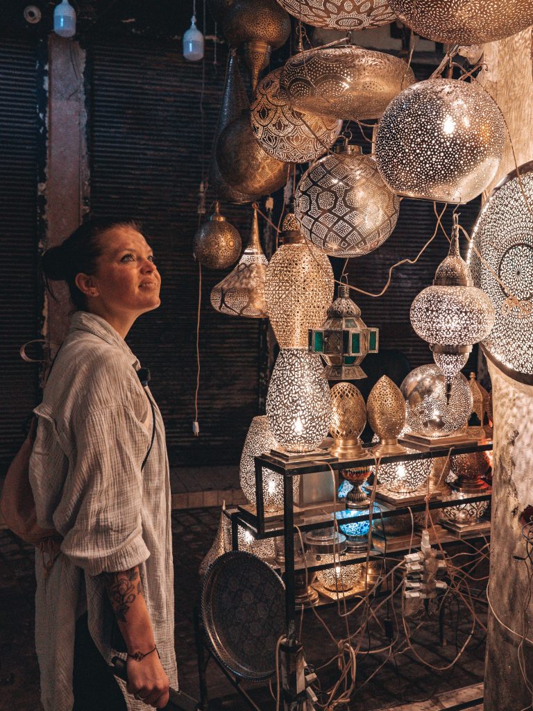 Anika zwischen glänzenden Messinglampen in den Souks von Marrakesch